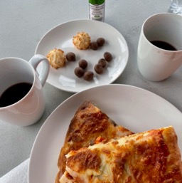Fancy dinner on the side of the road: pizza, crappy wine in mugs, coconut macaroons and bug repellant/
		    