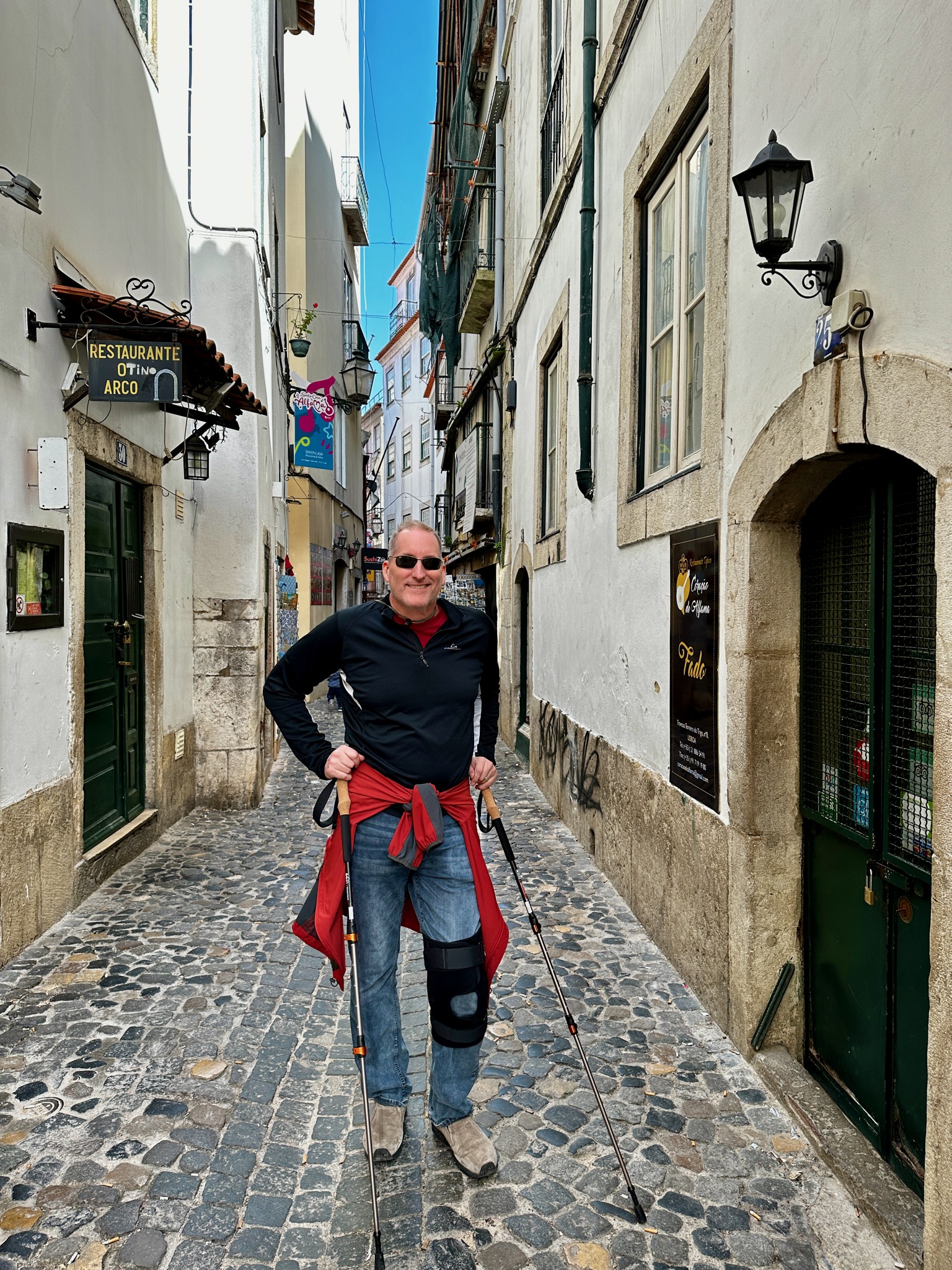 Knee brace and walking sticks! What a good sport!/R. de São Pedro 25B, 1100-605 Lisboa, Portugal