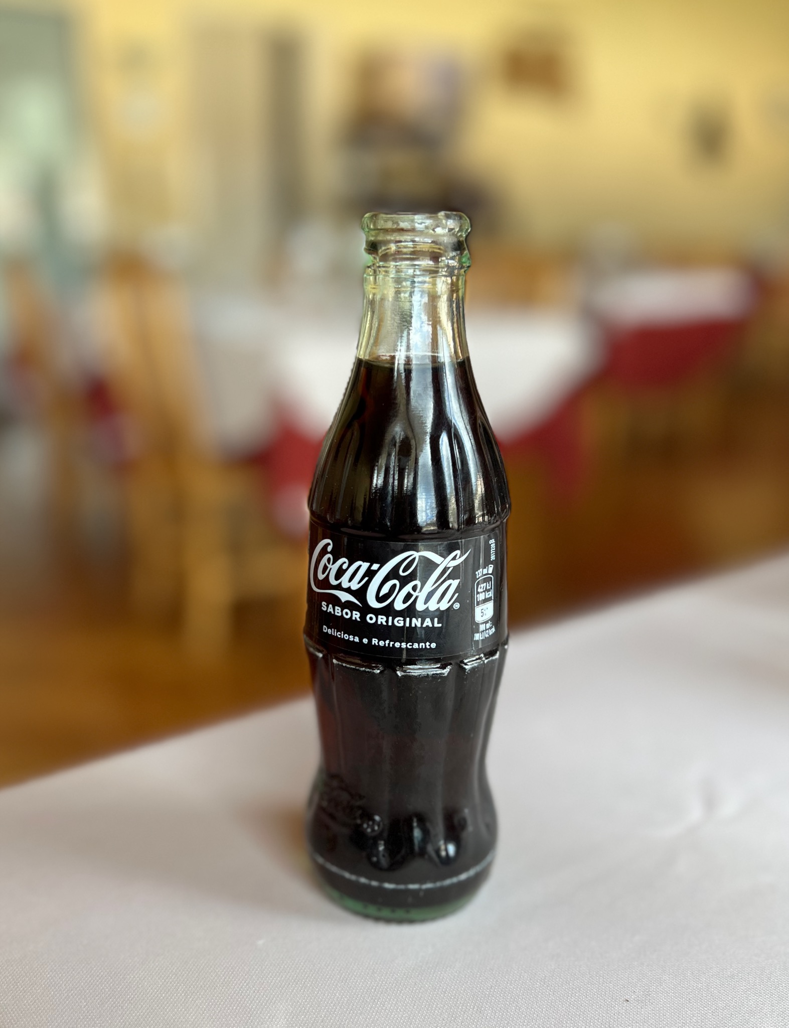 Teeniest ever coke bottle/R. 1º de Maio 9, 6260-188 Manteigas, Portugal