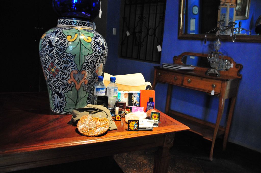 Two pant legs, a disk of peanuts and a bag of cookies, two bottles of water, the little camera and one iPhone, two guide books and the travel journal, the tiles we bought, lip-gloss, a bottle of hand sanitizer, and gum!/