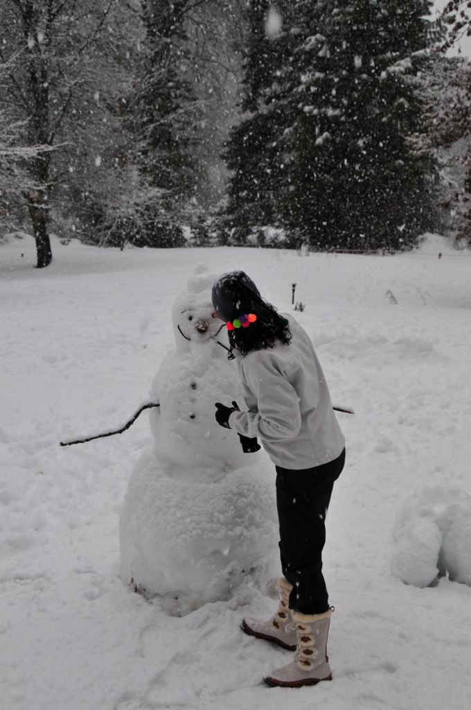 Assana fixing up the snowman/